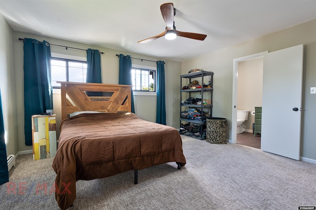 carpeted bedroom featuring ceiling fan, a baseboard radiator, and ensuite bath