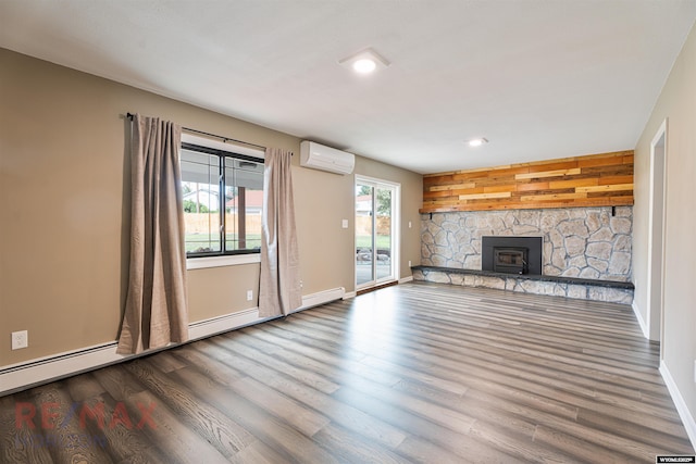 unfurnished living room with a wall mounted air conditioner and wood-type flooring