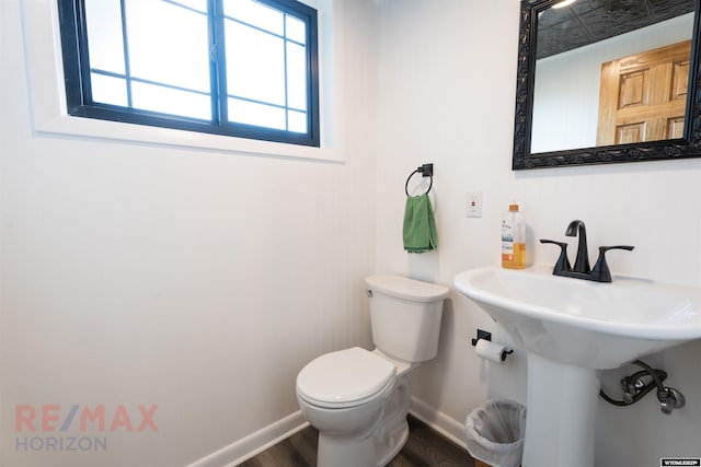 bathroom with hardwood / wood-style floors and toilet