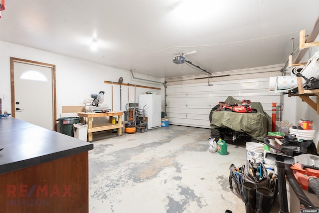 garage with white fridge and a garage door opener