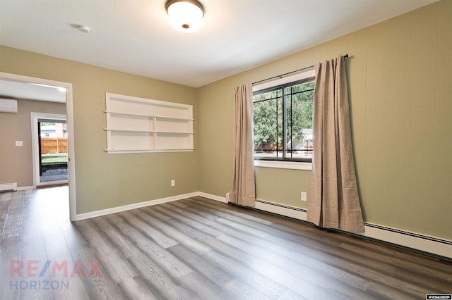 unfurnished room with built in shelves, wood-type flooring, and an AC wall unit