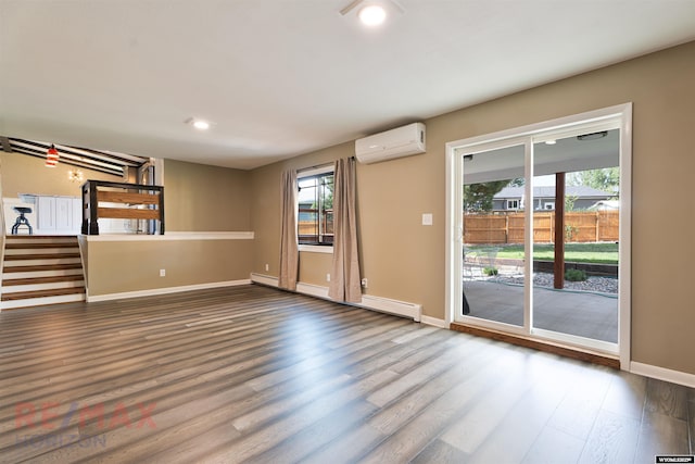 unfurnished room with hardwood / wood-style floors, a baseboard heating unit, and a wall mounted AC