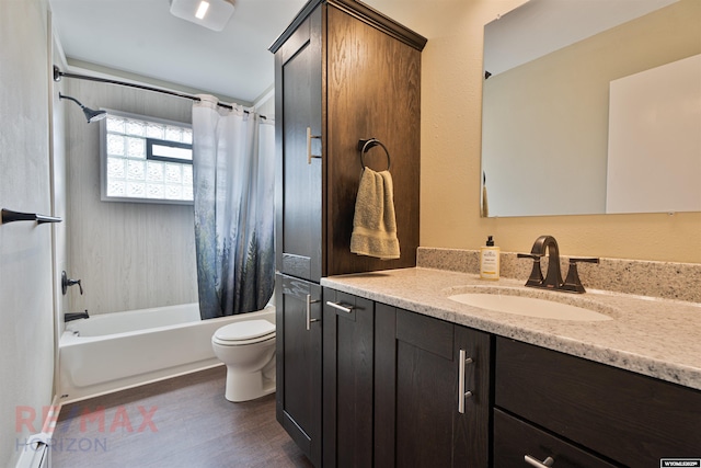 full bathroom featuring hardwood / wood-style flooring, vanity, shower / tub combo, and toilet