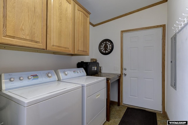 clothes washing area with crown molding, washing machine and clothes dryer, and cabinets