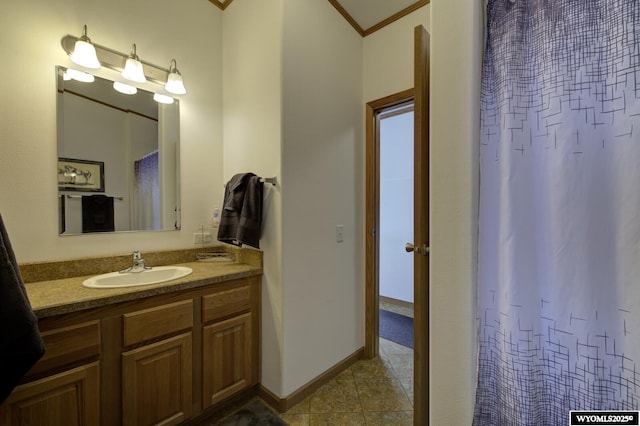 bathroom with crown molding and vanity