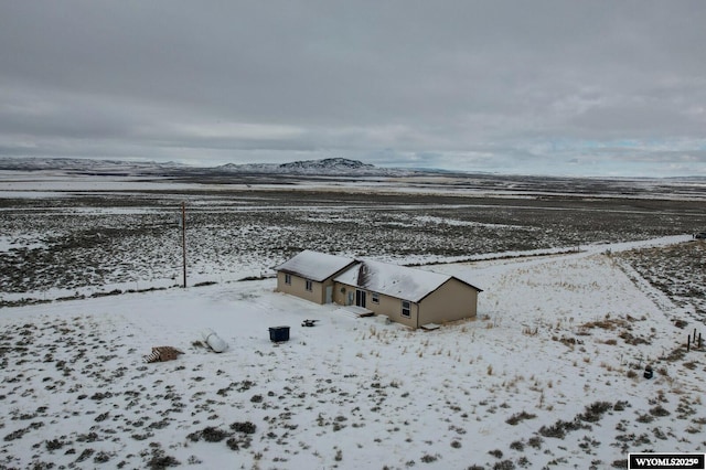 snowy aerial view with a mountain view