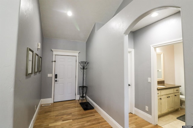 interior space featuring light wood-type flooring and lofted ceiling