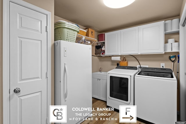 laundry area featuring dark hardwood / wood-style flooring, cabinets, and separate washer and dryer