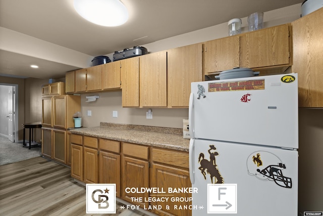 kitchen featuring light hardwood / wood-style floors and white refrigerator