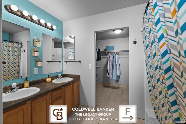 bathroom featuring vanity, a textured ceiling, tile patterned floors, and a shower with shower curtain