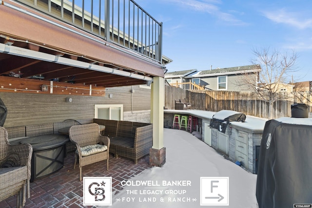 view of patio featuring a balcony, exterior kitchen, and grilling area