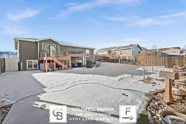 snow covered property with a deck