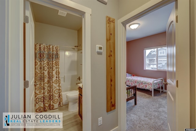 full bathroom featuring vanity, toilet, and shower / tub combo with curtain