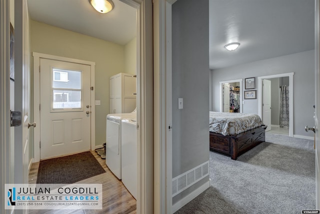 laundry area with light carpet and washing machine and clothes dryer