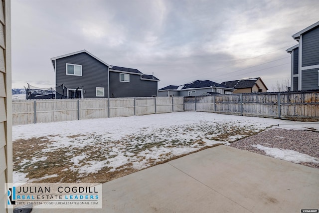 yard covered in snow featuring a patio area