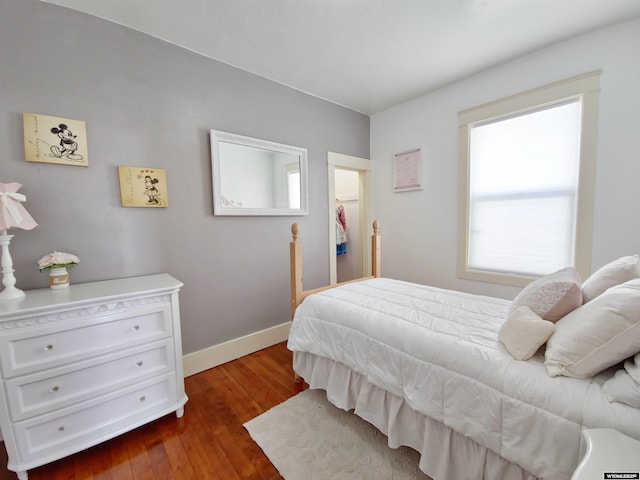 bedroom featuring dark hardwood / wood-style flooring and multiple windows