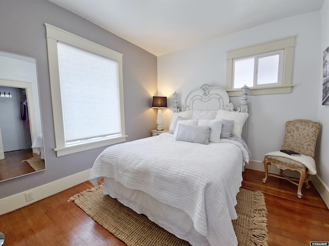 bedroom with dark wood-type flooring