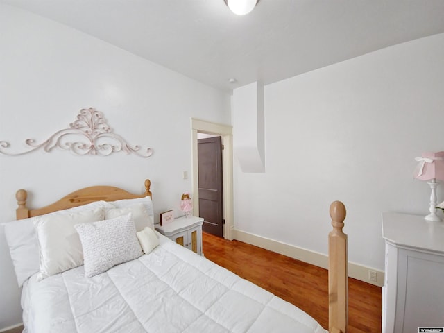 bedroom with hardwood / wood-style flooring