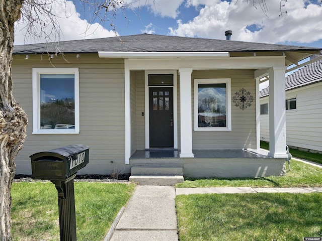 view of front of home with a porch and a front yard