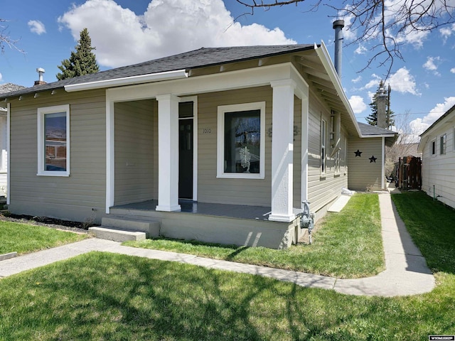 bungalow-style house with a front yard and a porch