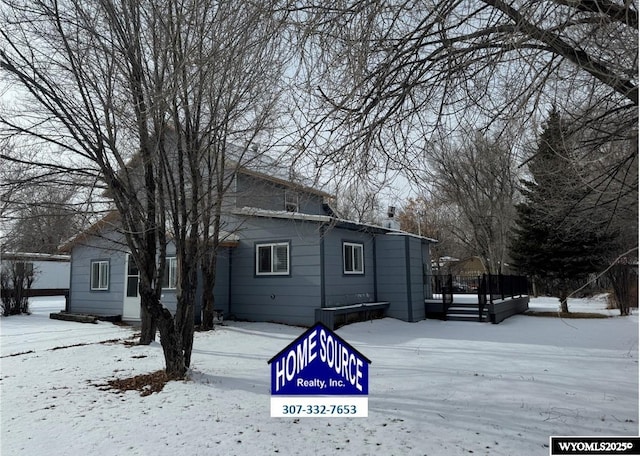 view of snow covered rear of property