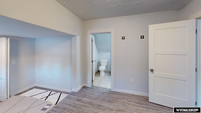 interior space featuring a textured ceiling and light hardwood / wood-style flooring