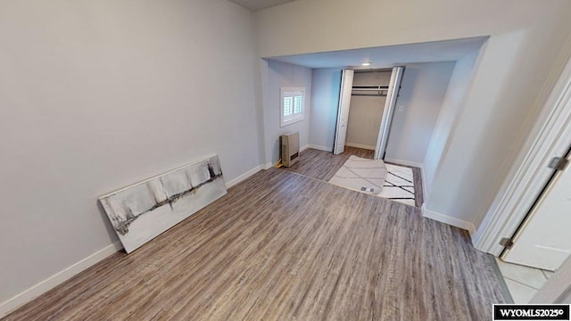 interior space featuring heating unit, a closet, and light hardwood / wood-style floors