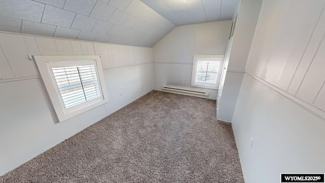 unfurnished room featuring carpet flooring, lofted ceiling, and a baseboard radiator