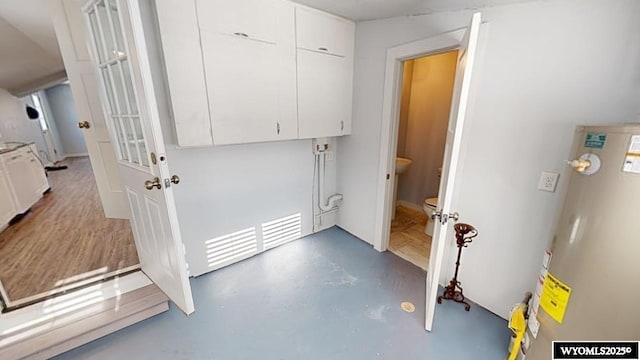 laundry room featuring gas water heater