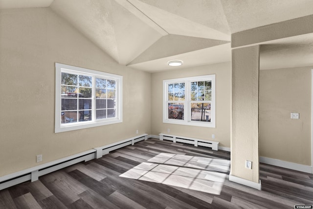 empty room with hardwood / wood-style flooring, plenty of natural light, vaulted ceiling, and a baseboard heating unit