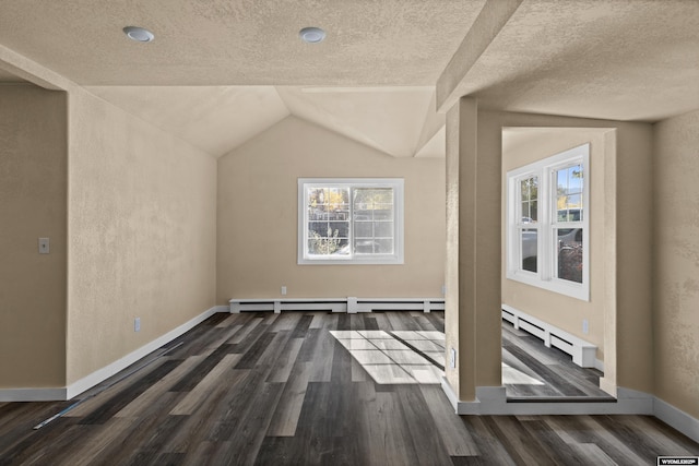 bonus room with a textured ceiling, vaulted ceiling, and dark wood-type flooring