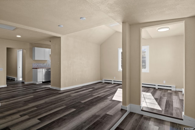 unfurnished living room featuring dark hardwood / wood-style floors, lofted ceiling, a textured ceiling, and a baseboard heating unit