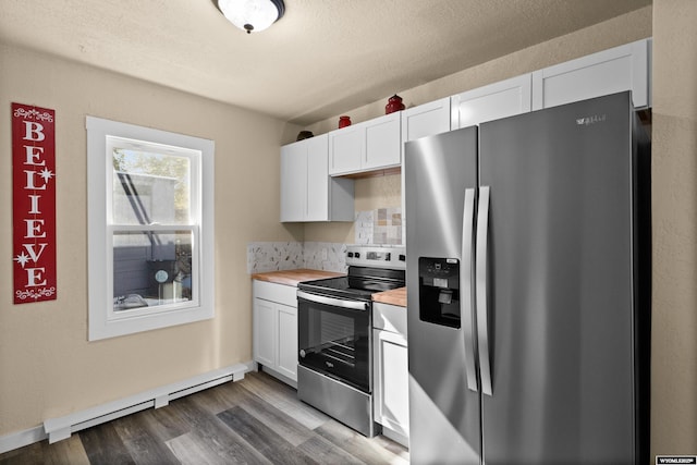 kitchen featuring butcher block counters, white cabinetry, stainless steel appliances, and a baseboard heating unit