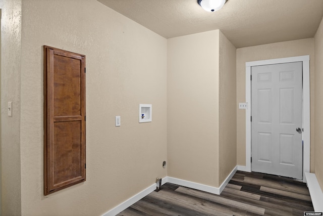 washroom featuring dark hardwood / wood-style floors, a textured ceiling, and hookup for a washing machine