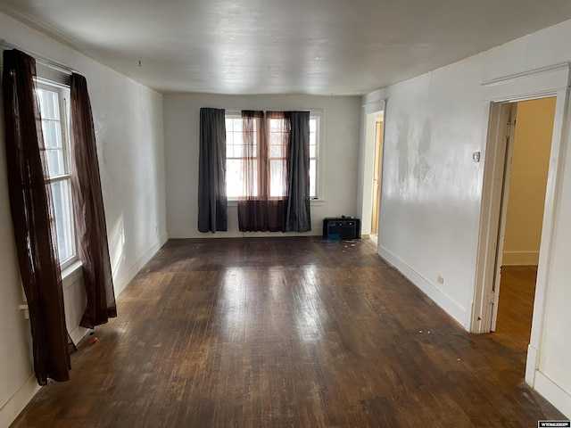 unfurnished room featuring dark hardwood / wood-style flooring