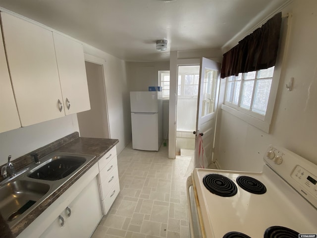 kitchen with white cabinets, white appliances, a wealth of natural light, and sink