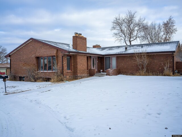 view of snow covered rear of property