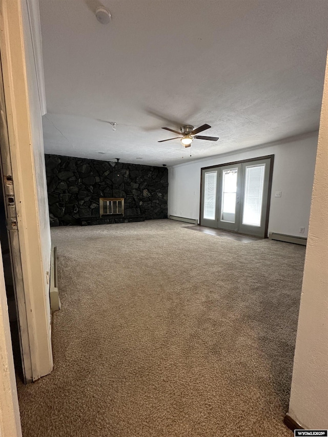 unfurnished living room with baseboard heating, carpet flooring, and ceiling fan