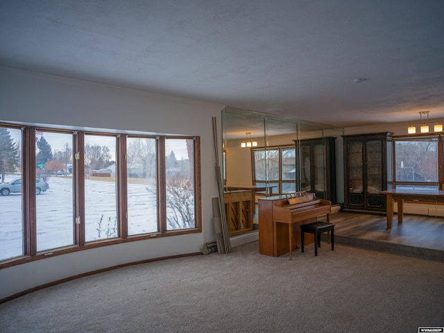 interior space featuring a chandelier and dark carpet