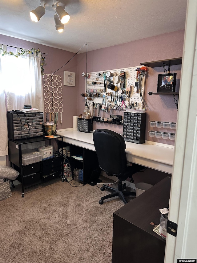 carpeted home office featuring a textured ceiling