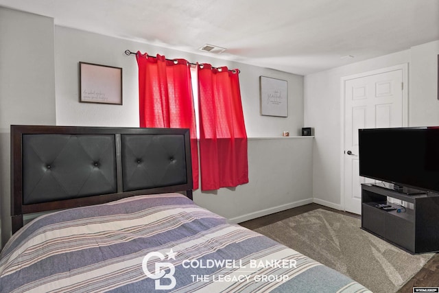 bedroom with baseboards and visible vents