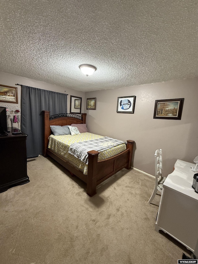 carpeted bedroom featuring a textured ceiling