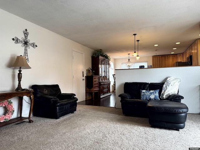 living room with carpet flooring and a textured ceiling