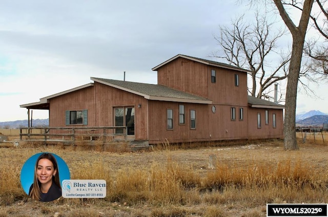 back of property with a mountain view