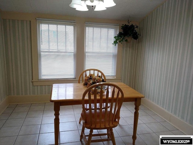 dining room with a chandelier and light tile patterned floors