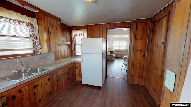 kitchen featuring white refrigerator, dark hardwood / wood-style flooring, and sink