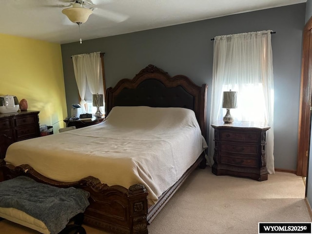 carpeted bedroom featuring ceiling fan and multiple windows