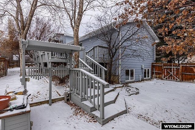 view of snow covered back of property