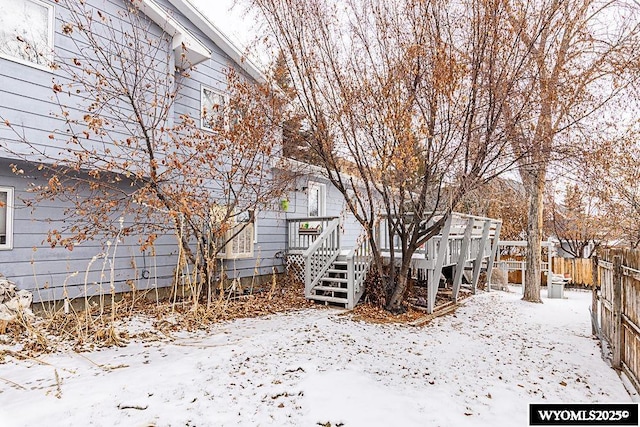 yard layered in snow with a deck