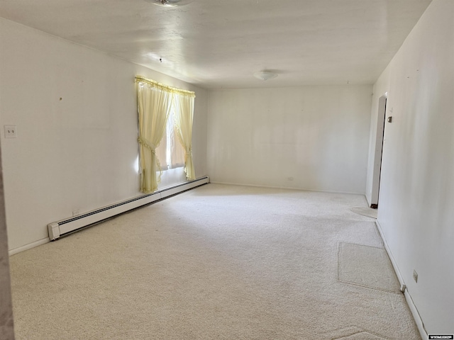 1101 Pine Ave, Kemmerer, WY 83101 - unfurnished room featuring a baseboard heating unit, carpet flooring, and baseboards